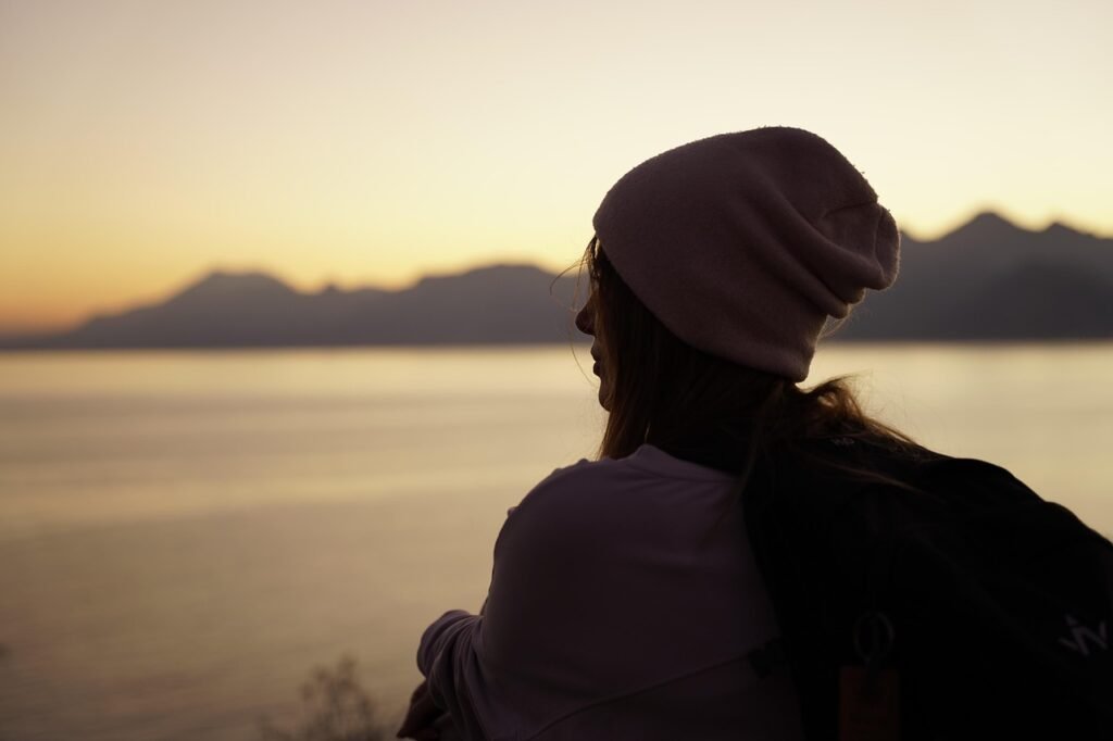 woman, outdoors, sunset, beanie, travel, thinking, looking, nature, nostalgia, dusk